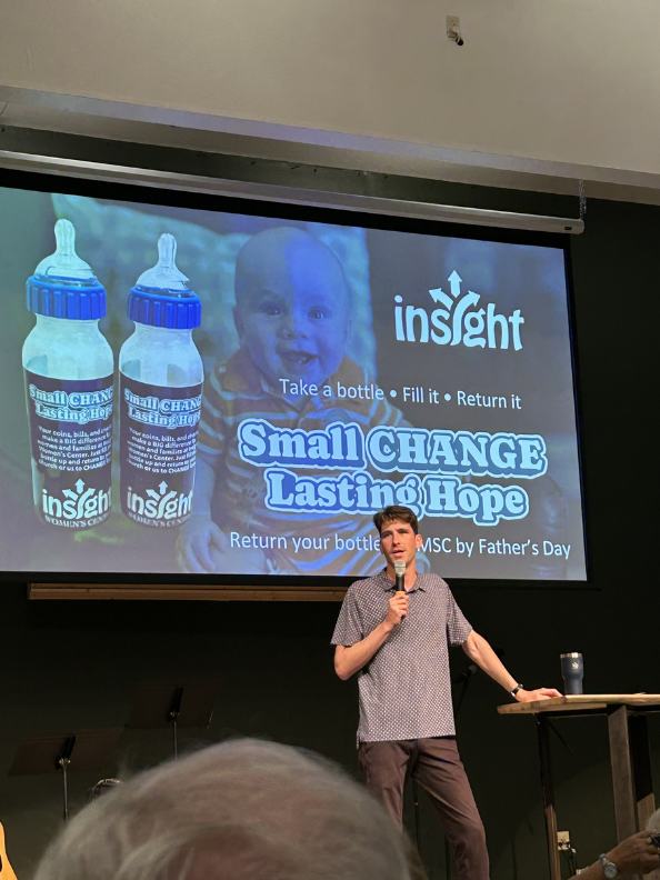 A speaker introducing the Baby Bottle Campaign to a church congregation