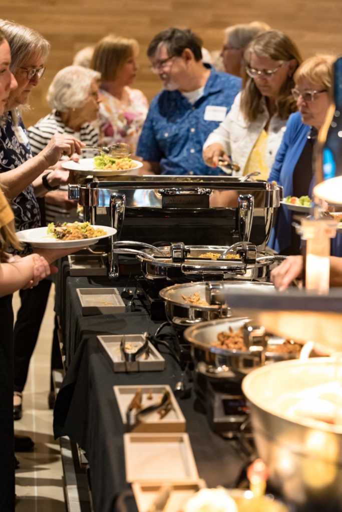 Guests serving themselves at the hors d’oeuvres buffet